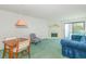 Relaxing living room including fireplace, outdoor access to the balcony, a table and blue couch at 311 69Th Ave. N # 302, Myrtle Beach, SC 29572