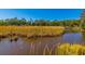 Serene marsh view featuring tall grasses, calm water, and a backdrop of lush trees at 311 69Th Ave. N # 302, Myrtle Beach, SC 29572