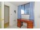 Home office with a wooden desk with drawers, curtains, and a view to an ensuite bathroom at 311 69Th Ave. N # 302, Myrtle Beach, SC 29572