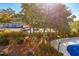 Overhead view of a covered pool with glimpses of the surrounding parking lot and lush foliage at 311 69Th Ave. N # 302, Myrtle Beach, SC 29572