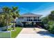 Inviting elevated beach house featuring a covered parking area and beautifully landscaped front yard at 312 35Th Ave. N, North Myrtle Beach, SC 29582