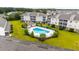 Aerial shot featuring a sparkling blue pool, surrounded by lounge chairs and lush greenery for ultimate relaxation at 318 Castle Dr. # 1443, Myrtle Beach, SC 29579