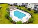 Overhead view of a community pool, complete with lounge chairs, umbrellas, and well-maintained landscaping at 318 Castle Dr. # 1443, Myrtle Beach, SC 29579