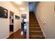 Welcoming entryway with staircase leading upstairs and view into the combined kitchen, dining, and living area at 318 Castle Dr. # 1443, Myrtle Beach, SC 29579