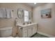 Bright bathroom featuring a double sink vanity, decorative mirrors, and beachy decor at 321 53Rd Ave. N, North Myrtle Beach, SC 29582