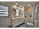 Bright bathroom with double sinks, white cabinets, and a shower-tub combination at 321 53Rd Ave. N, North Myrtle Beach, SC 29582