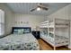 Comfortable bedroom with a ceiling fan, bunk beds, and a queen bed, perfect for families at 321 53Rd Ave. N, North Myrtle Beach, SC 29582