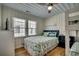 Cozy bedroom features a ceiling fan, white wood paneling, and blue bedding with a sea-themed design at 321 53Rd Ave. N, North Myrtle Beach, SC 29582