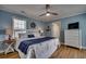 Coastal-themed bedroom features a king bed with blue accents, nautical decor, and a ceiling fan at 321 53Rd Ave. N, North Myrtle Beach, SC 29582
