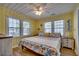 Cheerful bedroom features bright yellow walls, a ceiling fan, and a bed with colorful sea-themed bedding at 321 53Rd Ave. N, North Myrtle Beach, SC 29582