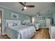 Bright and airy bedroom featuring two queen beds, a ceiling fan, and coastal themed decor at 321 53Rd Ave. N, North Myrtle Beach, SC 29582