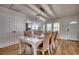 Inviting dining room featuring a table set for six, wood flooring, and ample natural light from the adjacent windows at 321 53Rd Ave. N, North Myrtle Beach, SC 29582
