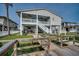Beautiful elevated home with a canal view, a spacious deck, and stairs to the main living area at 321 53Rd Ave. N, North Myrtle Beach, SC 29582