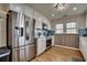Updated kitchen with stainless steel appliances, white cabinetry, a tile backsplash, and ample counter space for cooking at 321 53Rd Ave. N, North Myrtle Beach, SC 29582