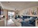 Cozy living room showcasing a large blue sectional, bright decor, and a sliding glass door leading to the outside at 321 53Rd Ave. N, North Myrtle Beach, SC 29582