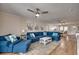 Bright living room featuring a blue sectional, ceiling fan, and open access to the kitchen and dining area at 321 53Rd Ave. N, North Myrtle Beach, SC 29582