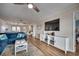Spacious living room features a large TV, white entertainment center, ceiling fan, and comfortable blue sectional at 321 53Rd Ave. N, North Myrtle Beach, SC 29582