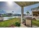 Relaxing patio with outdoor grill, green grass, a white picket fence, and canal view at 321 53Rd Ave. N, North Myrtle Beach, SC 29582