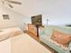Cozy bedroom with two beds, bench seat, starfish pillows, wood flooring, and a TV at 323 Wendover Ct. # 10-A, Myrtle Beach, SC 29572