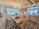 Open-concept dining area flowing to living room with wood floors and natural light at 323 Wendover Ct. # 10-A, Myrtle Beach, SC 29572