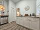 Kitchen with white cabinets, stainless dishwasher, and wood-look flooring at 323 Wendover Ct. # 10-A, Myrtle Beach, SC 29572