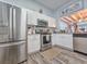 Well-lit kitchen featuring stainless steel appliances, white cabinets, and wood-look flooring at 323 Wendover Ct. # 10-A, Myrtle Beach, SC 29572