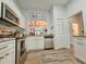 Kitchen with stainless appliances, white cabinets, and a pass-through window at 323 Wendover Ct. # 10-A, Myrtle Beach, SC 29572