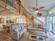 Bright living room with vaulted ceilings, wood staircase, and beachy accents at 323 Wendover Ct. # 10-A, Myrtle Beach, SC 29572