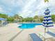 Inviting community pool with lounge chairs, umbrellas, and lush landscaping, perfect for relaxation at 323 Wendover Ct. # 10-A, Myrtle Beach, SC 29572