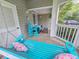 Inviting porch with a turquoise swing and comfortable seating at 323 Wendover Ct. # 10-A, Myrtle Beach, SC 29572