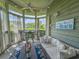 Relaxing screened porch featuring comfortable seating, ceiling fan, and views of the surrounding landscape at 323 Wendover Ct. # 10-A, Myrtle Beach, SC 29572