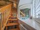 Wooden staircase leading to the mezzanine, next to the window seat at 323 Wendover Ct. # 10-A, Myrtle Beach, SC 29572