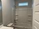 Clean bathroom with a shower-tub combination and built-in shelves for storage at 3333 Sw Wood Stork Dr., Ocean Isle Beach, NC 28469