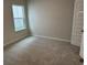 Bright bedroom with plush carpet and a large window providing ample natural light at 3333 Sw Wood Stork Dr., Ocean Isle Beach, NC 28469
