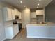 Contemporary kitchen with white cabinets, subway tile backsplash, and stainless steel appliances at 3333 Sw Wood Stork Dr., Ocean Isle Beach, NC 28469