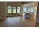 Spacious living room featuring wood-look flooring and bright windows at 3333 Sw Wood Stork Dr., Ocean Isle Beach, NC 28469