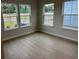 Bright, open room with wood-look flooring and several large windows at 3333 Sw Wood Stork Dr., Ocean Isle Beach, NC 28469