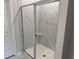 Modern shower with glass doors and marble tile at 3333 Sw Wood Stork Dr., Ocean Isle Beach, NC 28469