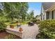 A well-manicured backyard with a stone patio, lawn, and mature trees at 341 Bahama Dr., Murrells Inlet, SC 29576