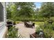 Beautiful brick patio features an outdoor dining set and lush, landscaped backyard at 341 Bahama Dr., Murrells Inlet, SC 29576
