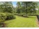 Lush backyard with a bench, mature trees, and well-manicured lawn at 341 Bahama Dr., Murrells Inlet, SC 29576