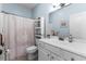 Bright bathroom featuring a single sink with white cabinetry and a shower with a patterned curtain at 341 Bahama Dr., Murrells Inlet, SC 29576
