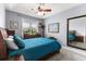 A comfortable bedroom with a ceiling fan, a window overlooking a manicured lawn, and dark wooden furniture at 341 Bahama Dr., Murrells Inlet, SC 29576