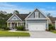 Charming single-Gathering home with blue siding, well-manicured lawn, and two-car garage in a friendly neighborhood at 341 Bahama Dr., Murrells Inlet, SC 29576