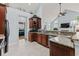Well-equipped kitchen featuring dark wood cabinetry, granite countertops, and stainless steel appliances for easy meals at 341 Bahama Dr., Murrells Inlet, SC 29576