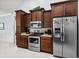 Charming kitchen with dark cabinets, granite countertops, and stainless appliances provides a functional cooking space at 341 Bahama Dr., Murrells Inlet, SC 29576
