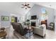 Open-concept living room with vaulted ceilings, fireplace, hardwood floors, and ample natural light at 341 Bahama Dr., Murrells Inlet, SC 29576