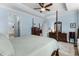 A spacious primary bedroom featuring blue walls, a ceiling fan, and wooden furniture at 341 Bahama Dr., Murrells Inlet, SC 29576