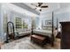 Main bedroom showcasing a bay window, seating area, and ceiling fan providing a relaxing retreat at 341 Bahama Dr., Murrells Inlet, SC 29576