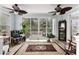 Bright sun room featuring dual ceiling fans and sliding glass doors to the backyard patio at 341 Bahama Dr., Murrells Inlet, SC 29576